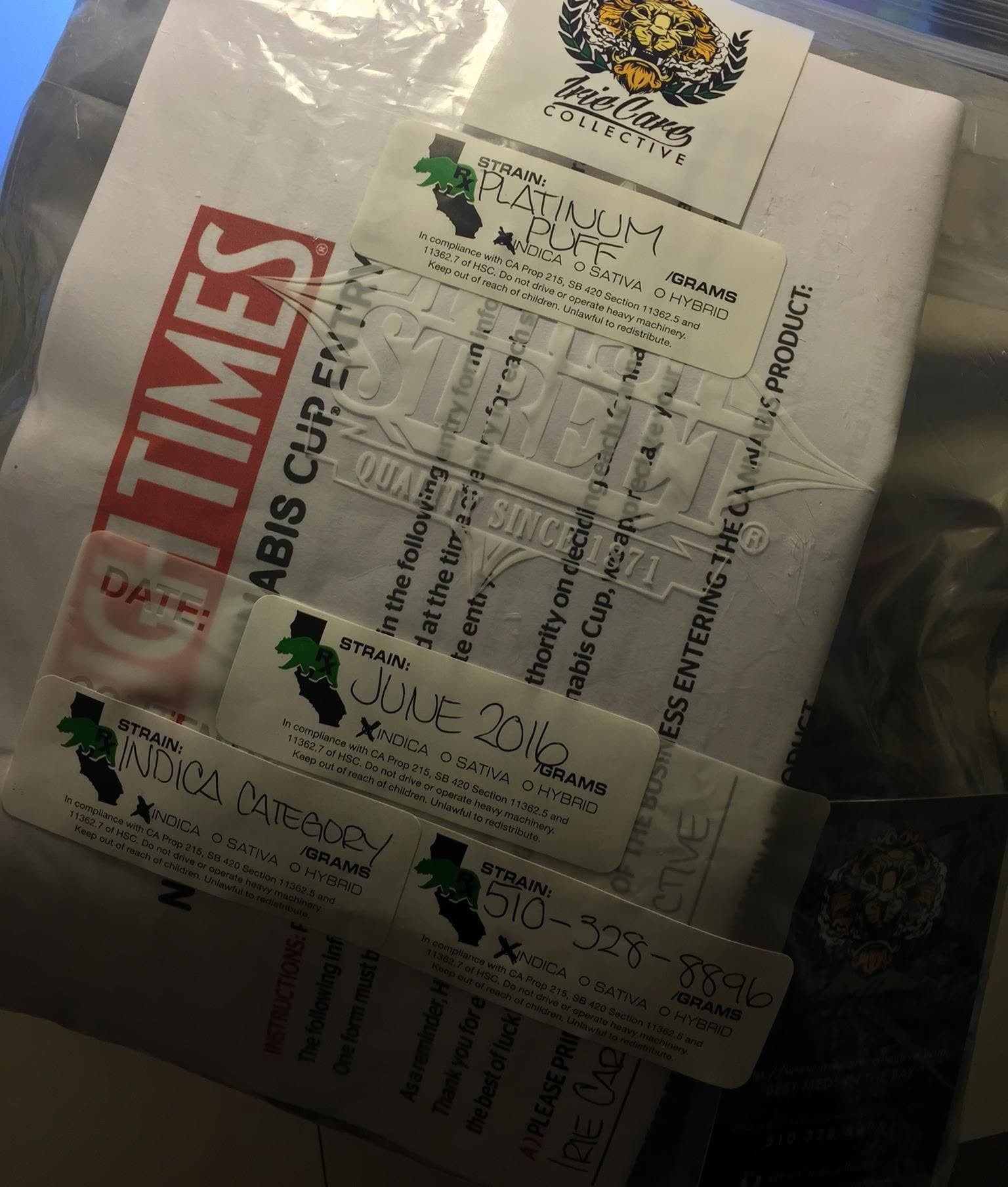A Cannabis Cup entry bag with an Irie Care sticker and handwritten Prop 215 labels reading Platinum Puff, June 2016 and Indica Category.